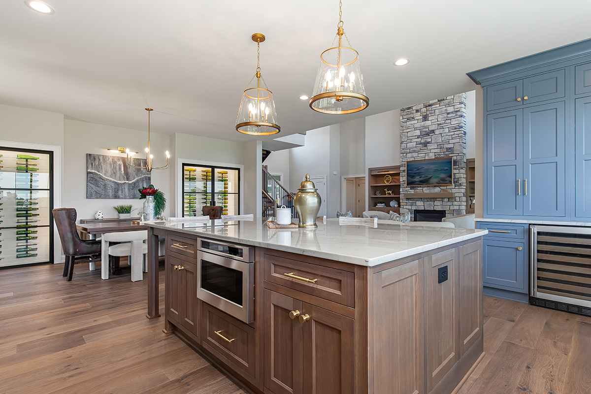 Kitchen with painted perimeter cabinets and stained island cabinets