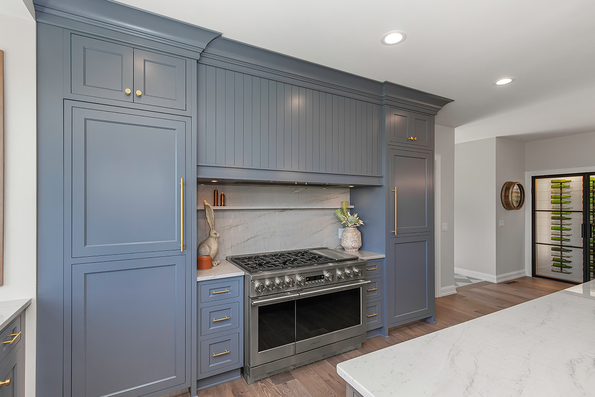 Kitchen with painted perimeter cabinets and stained island cabinets