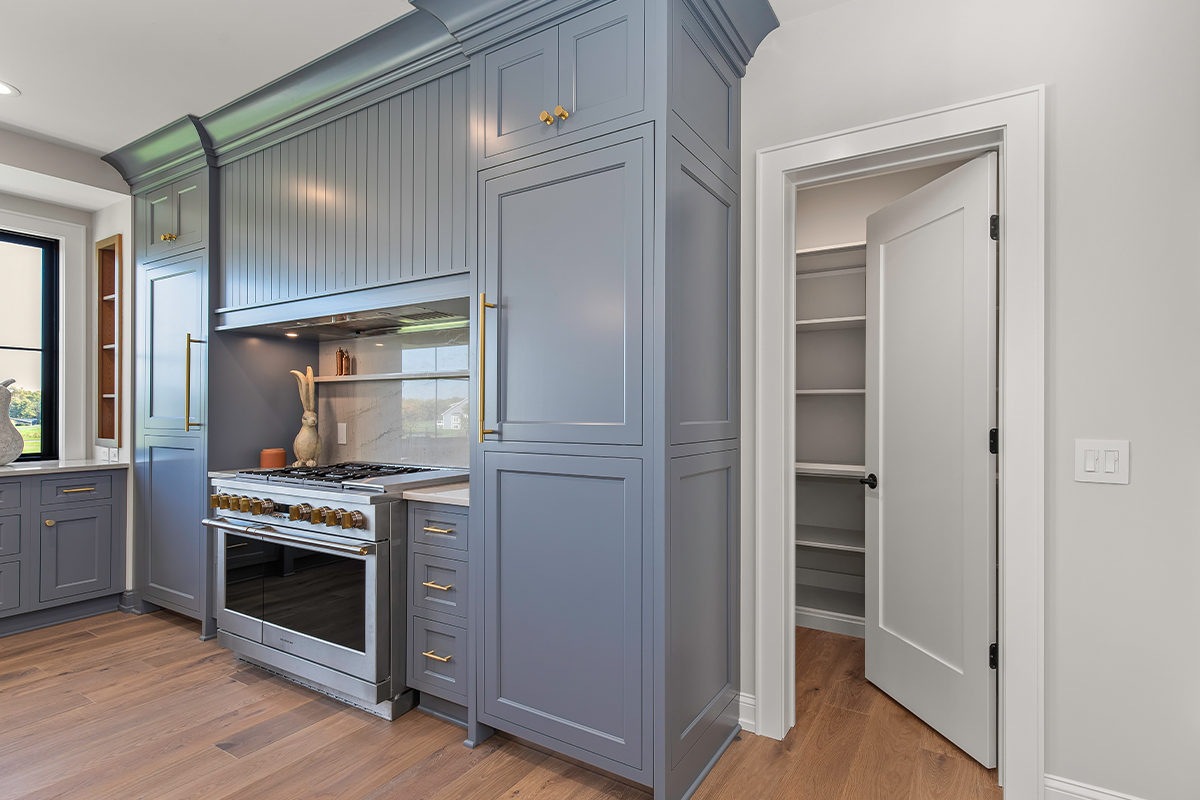 Kitchen with painted perimeter cabinets and stained island cabinets