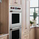 Double oven in stained kitchen cabinets