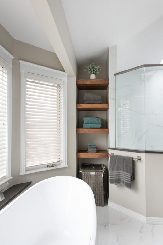 linen closet with stained shelves holding towels