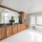 Walnut bathroom cabinets with 2 sinks and countertop storage on each end.