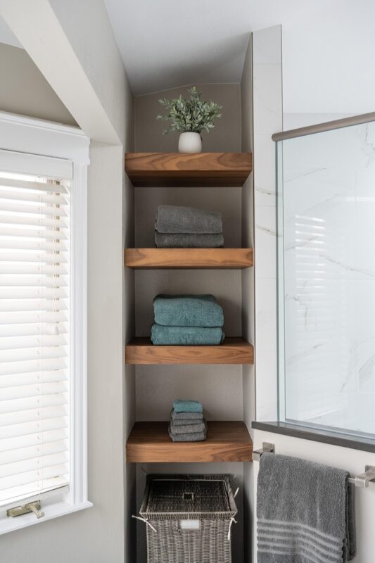 linen storage showing stained shelves holding towels