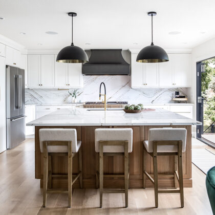 Kitchen with white painted perimeter cabinets and an island in quartersawn white oak with natural finish