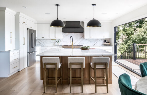 Kitchen with white painted perimeter cabinets and an island in quartersawn white oak with natural finish