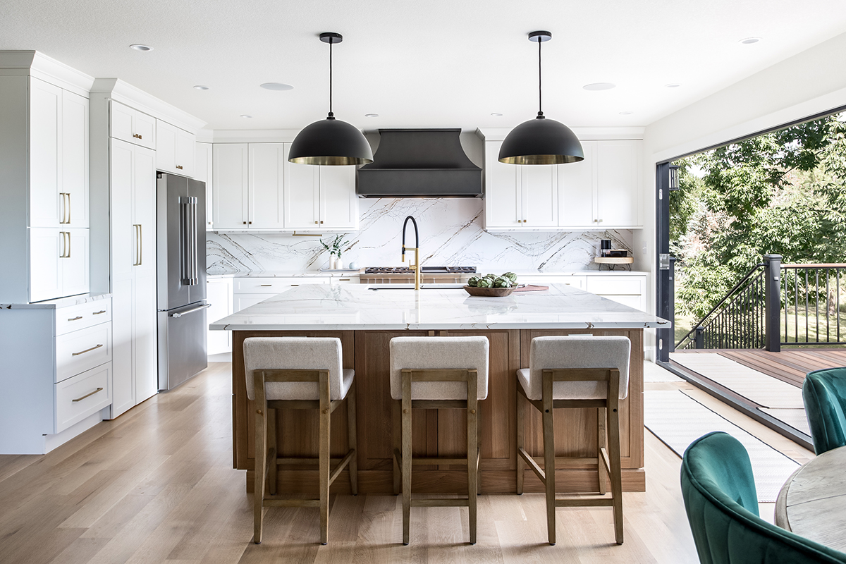 Kitchen with white painted perimeter cabinets and an island in quartersawn white oak with natural finish