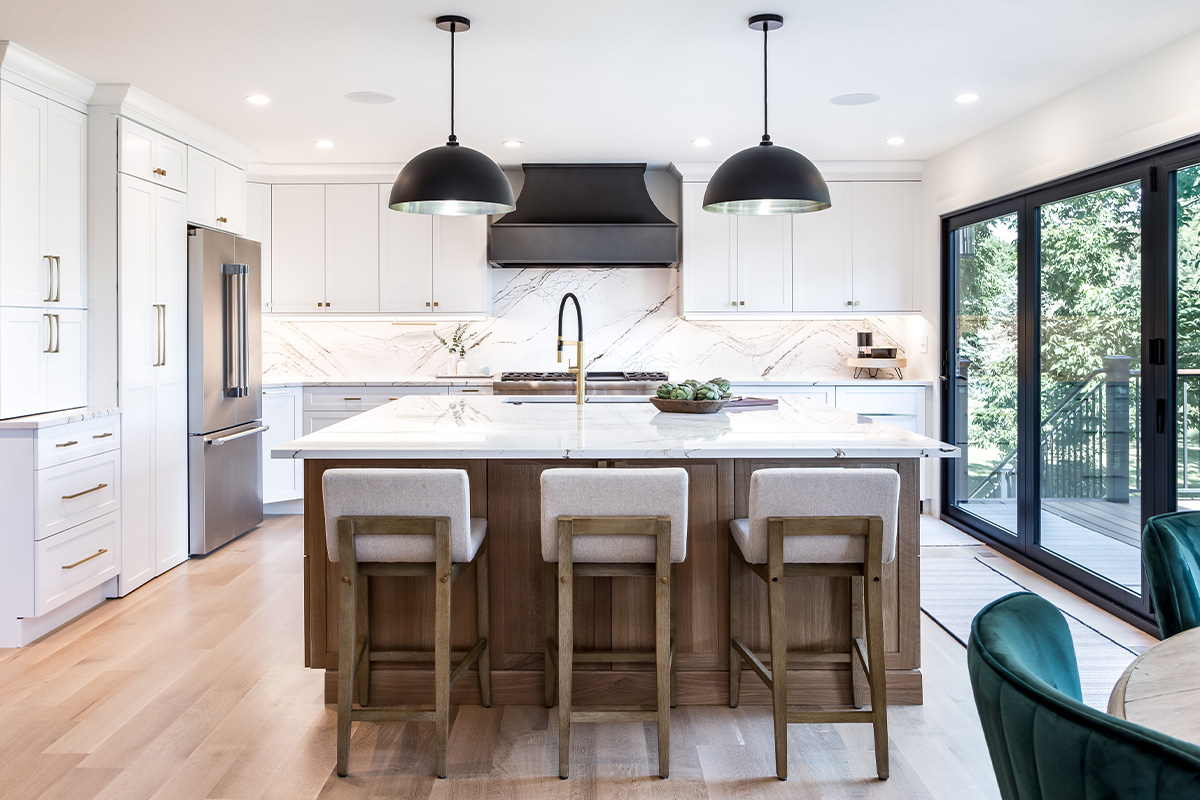 Kitchen with white painted perimeter cabinets and an island in quartersawn white oak with natural finish