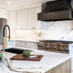 white kitchen cabinets with metal hood and stove