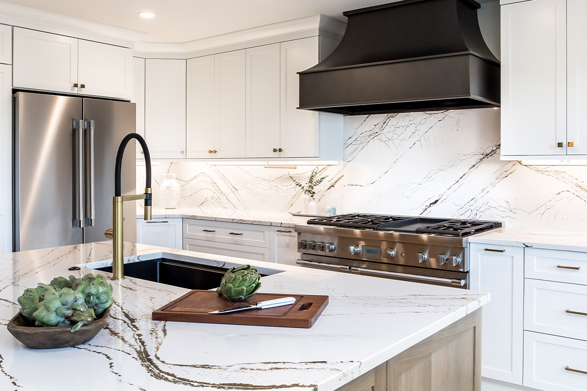 white kitchen cabinets with metal hood and stove