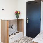 Mudroom cabinets with dog bowls encased in a doorless cabinet