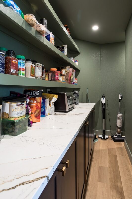 Dark stained pantry cabinets and floating shelves