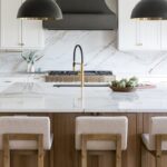 Kitchen with white painted perimeter cabinets and an island in quartersawn white oak with natural finish