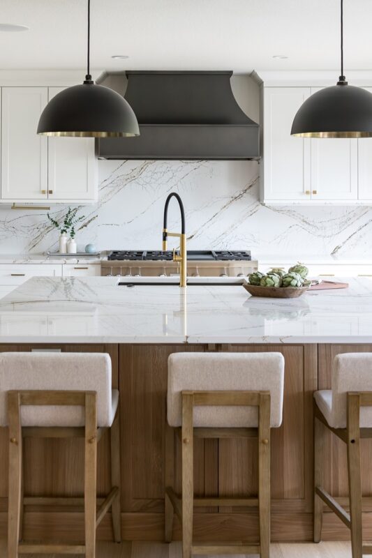 Kitchen with white painted perimeter cabinets and an island in quartersawn white oak with natural finish