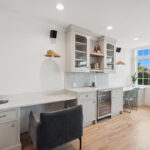 Desk and bar area with gray painted cabinets