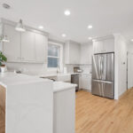 Painted kitchen cabinets including a stainless steel fridge