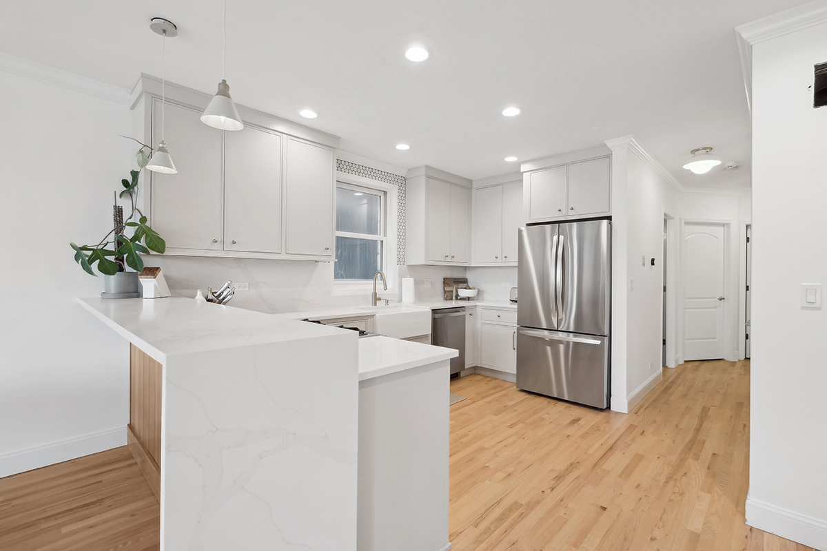 Painted kitchen cabinets including a stainless steel fridge