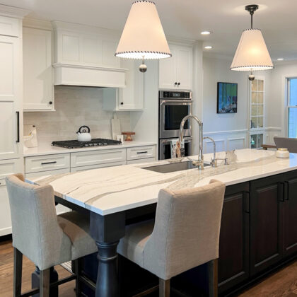 Kitchen with white perimeter and island finished in Midnight stain
