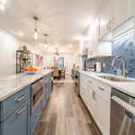 Kitchen with white perimeter cabinets and Smokey Blue island