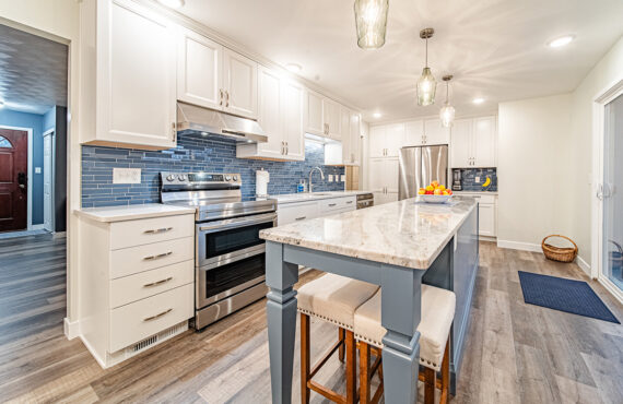 Kitchen with white perimeter cabinets and Smokey Blue island