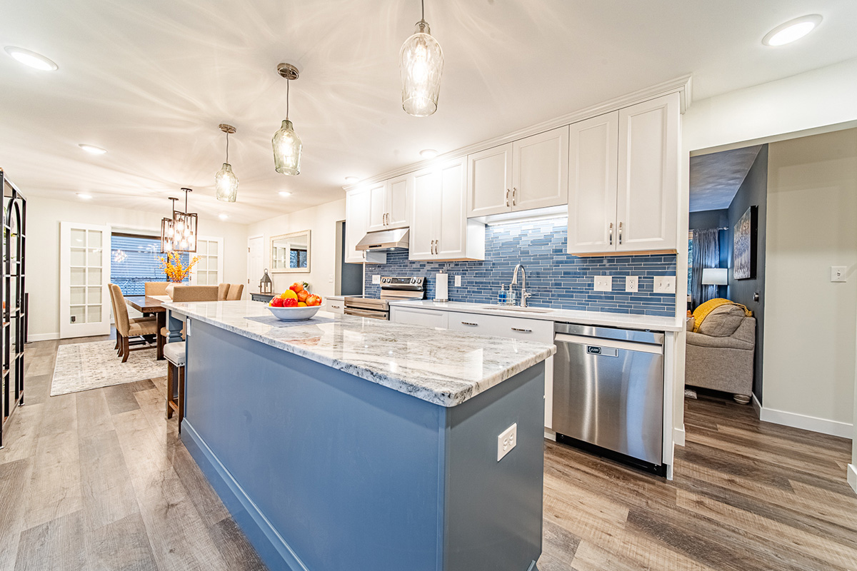 Kitchen with white perimeter cabinets and Smokey Blue island