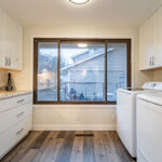 Laundry room with white cabinets and washer and dryer