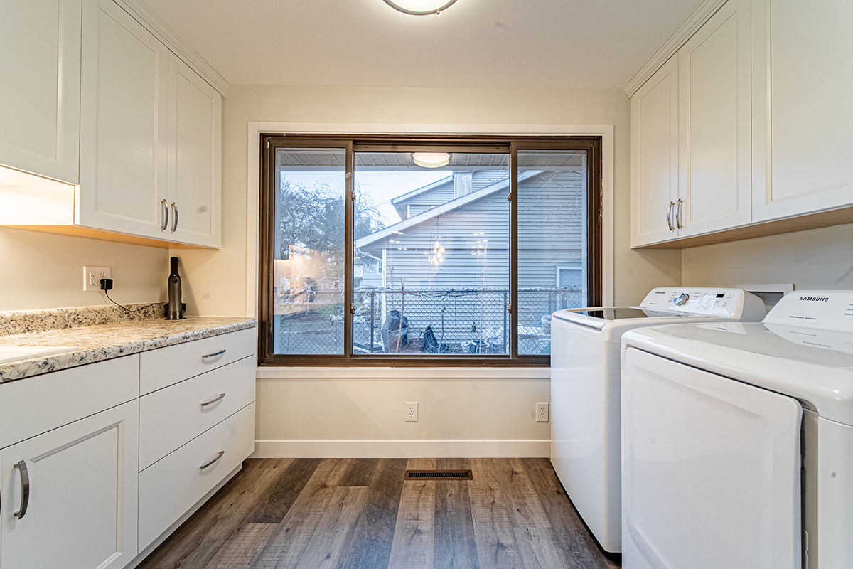 Laundry room with white cabinets and washer and dryer