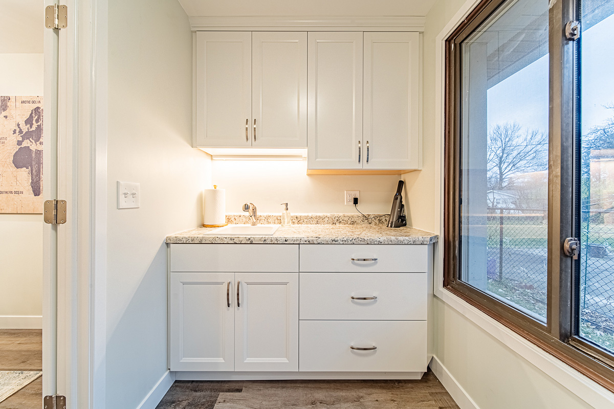 Mudroom with white cabinets