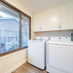 Laundry room with white cabinets and washer and dryer