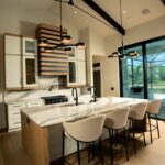 Contemporary and transitional kitchen and island with high ceilings and wood beams.