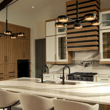 Contemporary and transitional kitchen and island with high ceilings and wood beams.