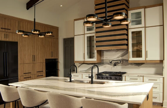 Contemporary and transitional kitchen and island with high ceilings and wood beams.