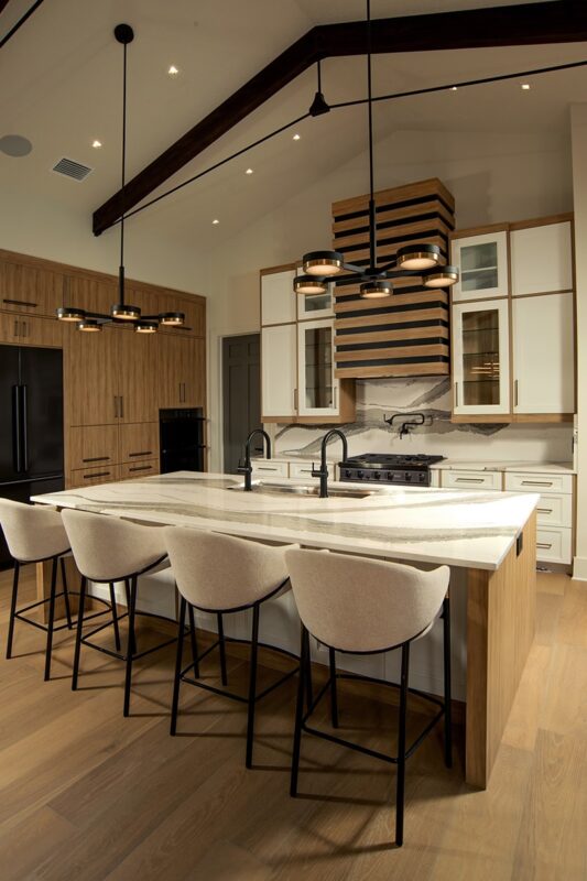 Contemporary and transitional kitchen and island with high ceilings and wood beams.