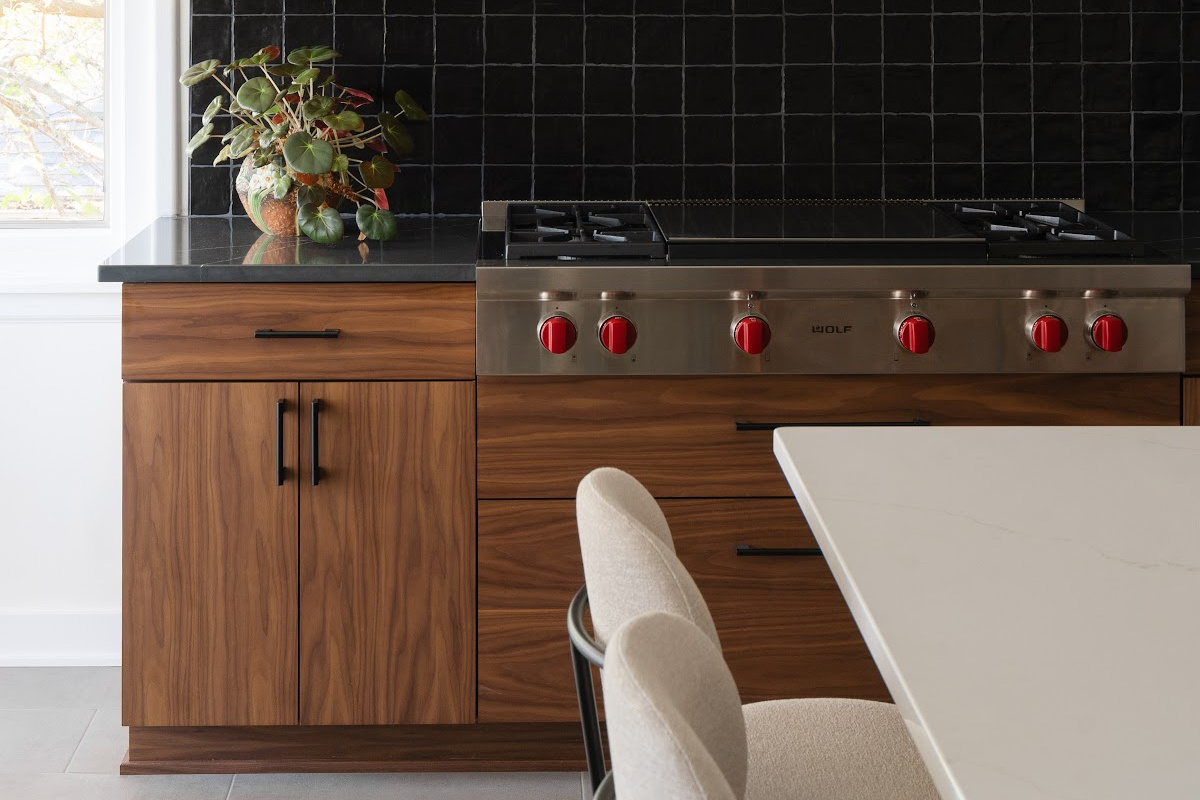 Contemporary kitchen in stained walnut with black tile backsplash