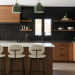 Contemporary kitchen in stained walnut with black tile backsplash