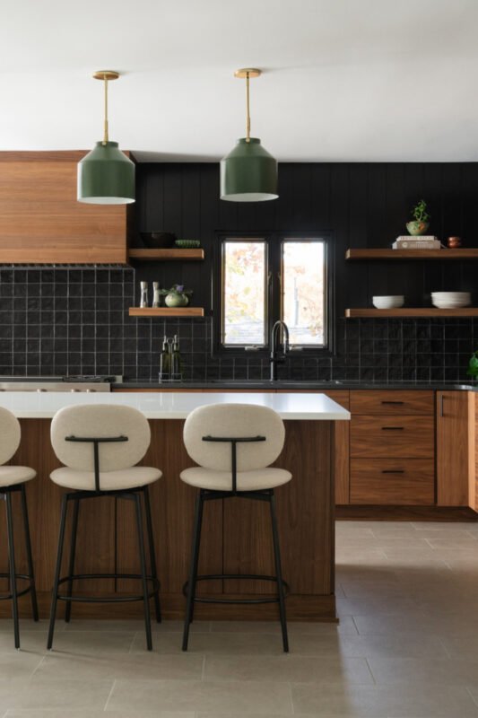 Contemporary kitchen in stained walnut with black tile backsplash