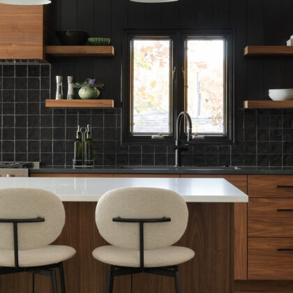 Contemporary kitchen in stained walnut with black tile backsplash