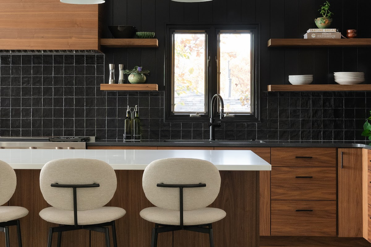 Contemporary kitchen in stained walnut with black tile backsplash