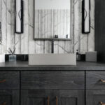 Bathroom vanity cabinets with dark Midnight stain. Bathroom uses "Woods" wall paper.