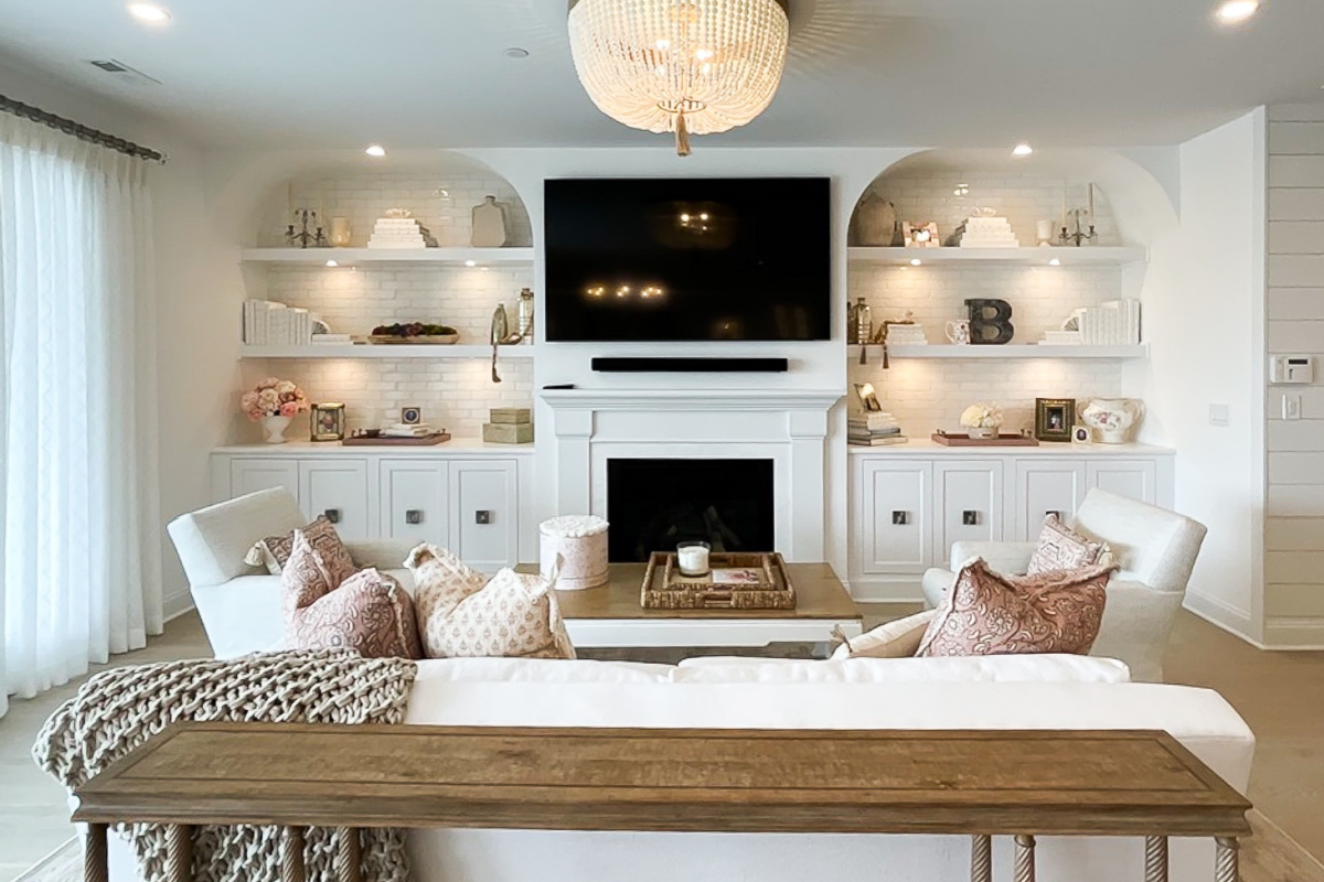 Entertainment Center in painted white cabinets and fireplace surround