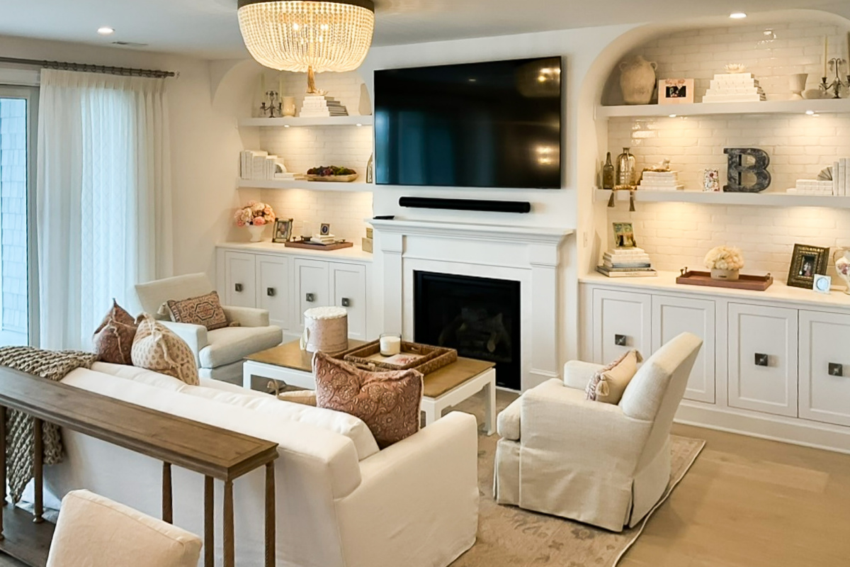 Entertainment Center in painted white cabinets and fireplace surround