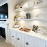 Entertainment Center in painted white cabinets and fireplace surround