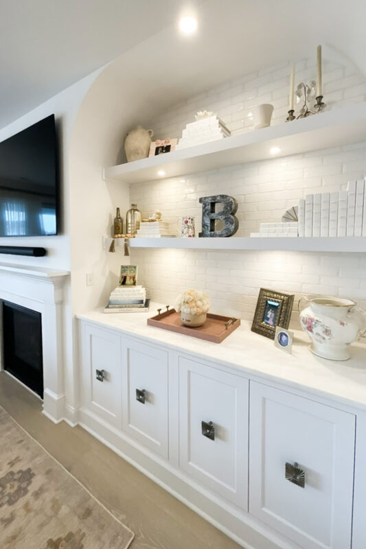 Entertainment Center in painted white cabinets and fireplace surround