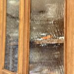 Stained cabinet showing the details of decorative glass in the cabinet door.