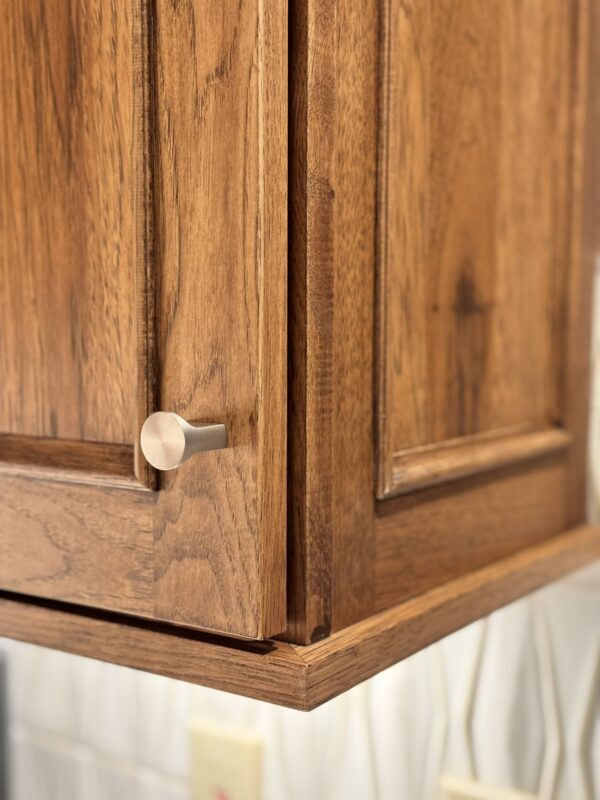 Stained kitchen cabinet. Photo shows detail of the applied molding Savannah door style
