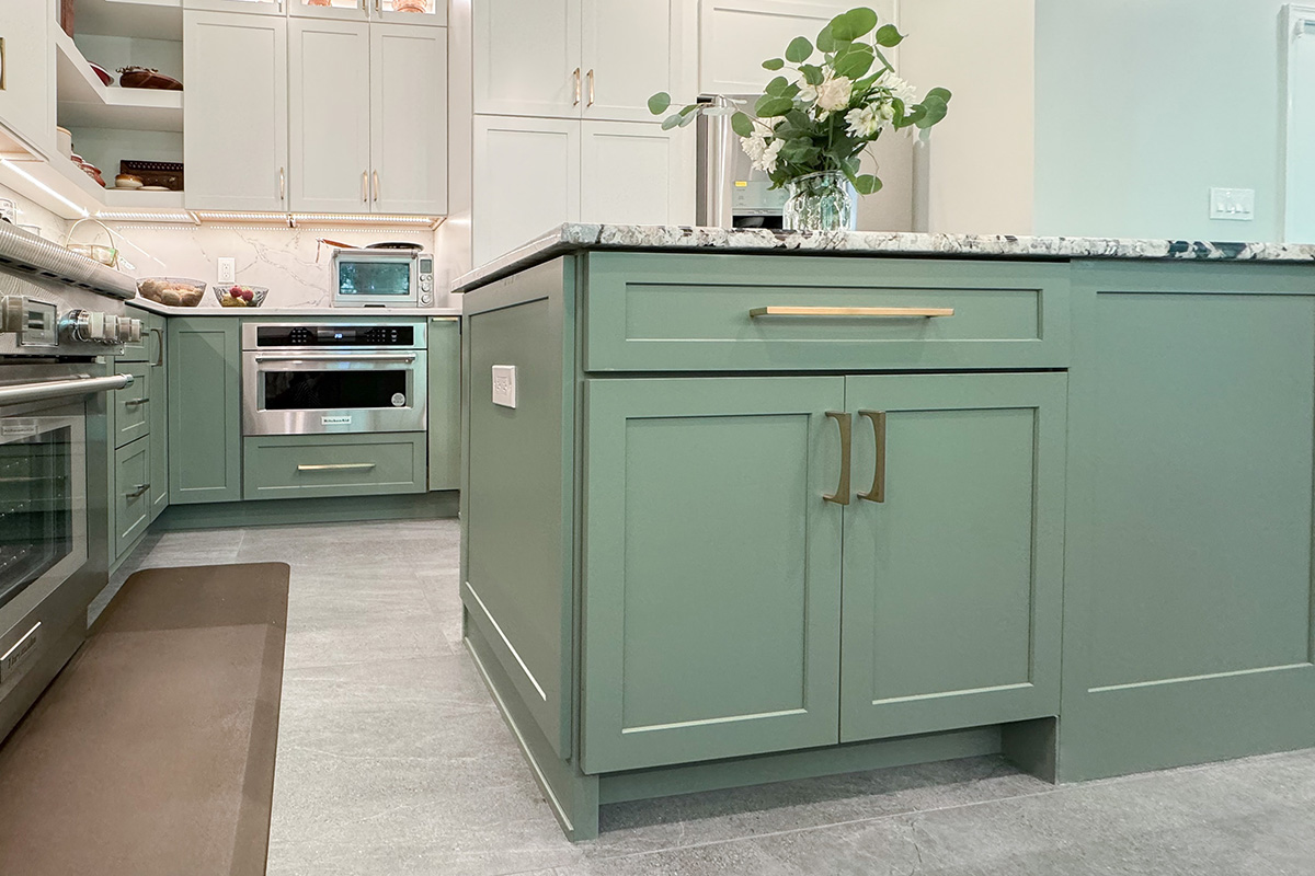 Painted kitchen cabinets in green bases and white wall cabinets