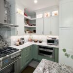 Painted kitchen cabinets in green bases and white wall cabinets