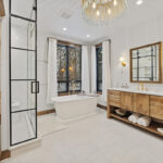 Rustic Hickory bathroom vanity with standalone tub and shower with glass walls