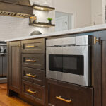 Stained kitchen island showing under counter microwave