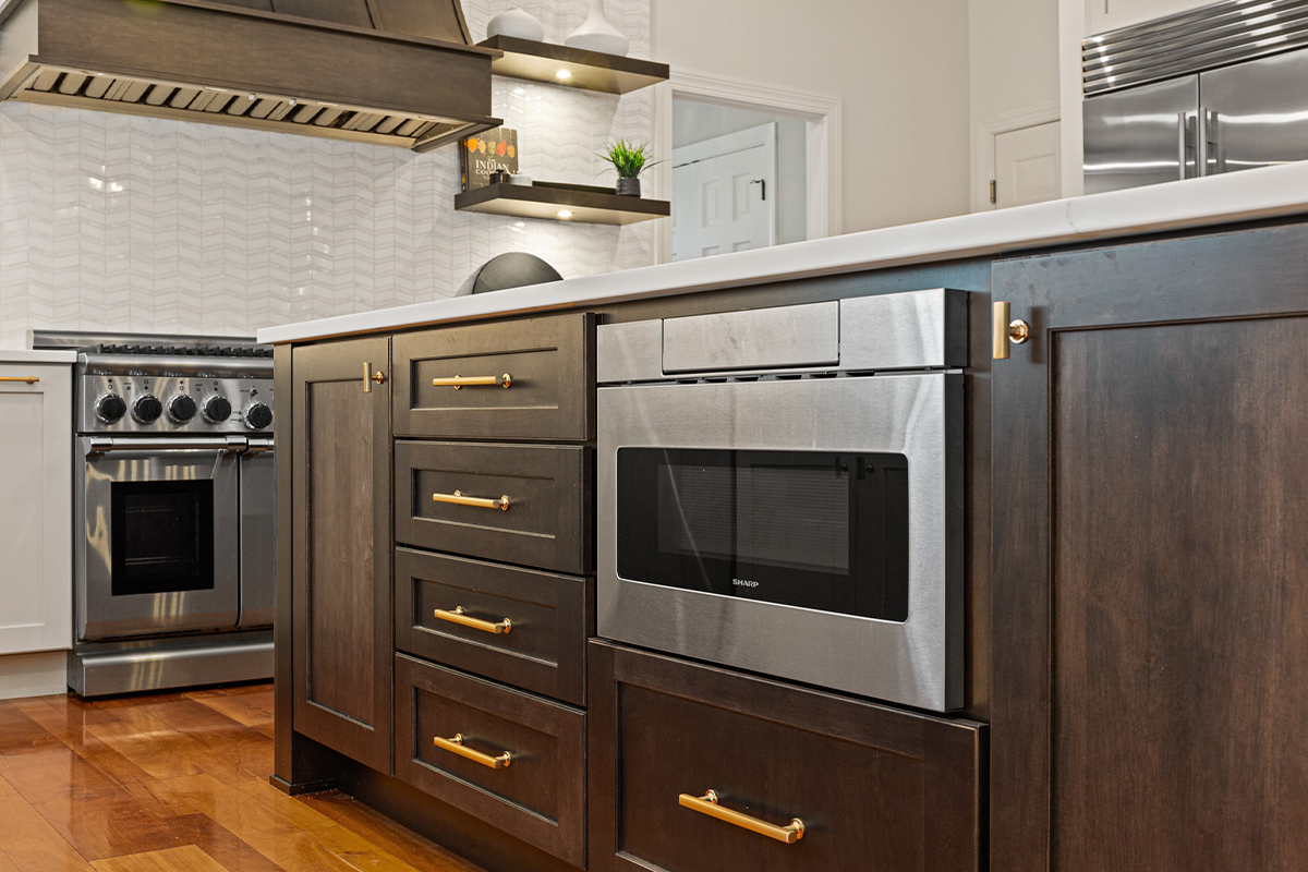 Stained kitchen island showing under counter microwave