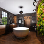 Contemporary bathroom with standalone tub and a wall of vines